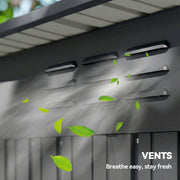Close-up of the roof vent slots on the shed with leaves blowing past
