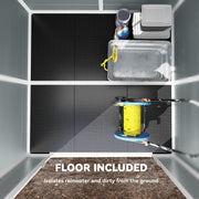 Shed interior with the built-in floor panel highlighted below a hose reel and storage boxes