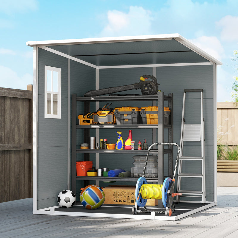 Open pent-roof shed with a workbench and power tools stored on the shelves inside