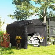 Black storage tent on a lawn with a motorbike parked inside
