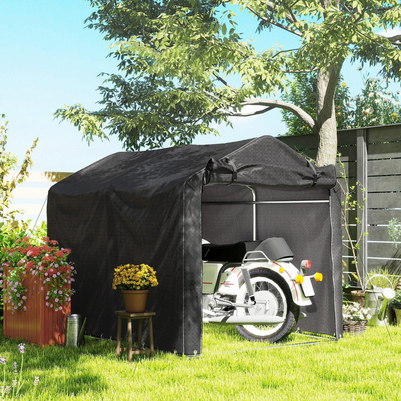 Black storage tent on a lawn with a motorbike parked inside