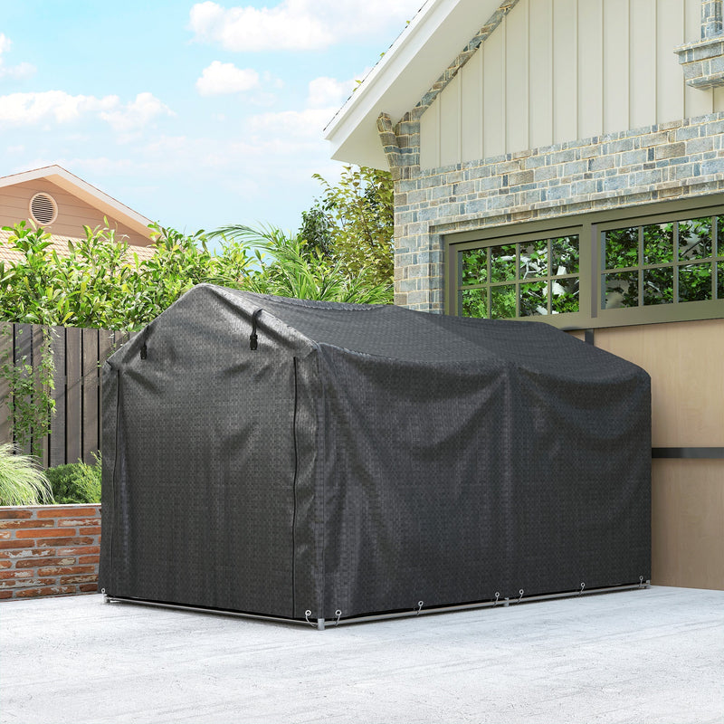 Black storage tent on a driveway beside a garage