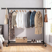 Songmics garment rail with coats and bags in a bedroom setting