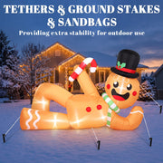 Gingerbread man held down with tether ropes and ground stakes on a snowy lawn