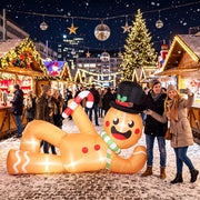 Two people taking a selfie with the gingerbread man at a Christmas market
