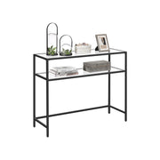 Black console table styled with lanterns above books on the lower tier