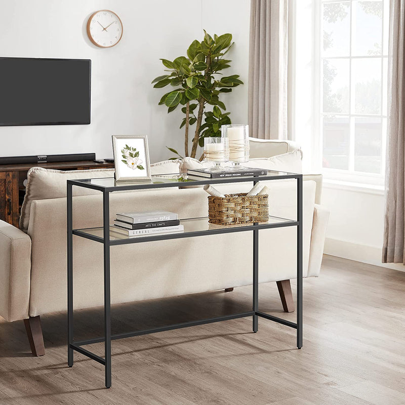 Black console table behind a cream sofa next to a media unit