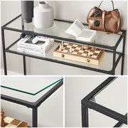 Close-up of the black console tiers holding books, a bag and a chess set
