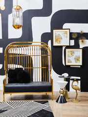 Gold dome cage sofa positioned in a furnished living room