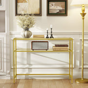 Gold glass console table styled in a living room with decor