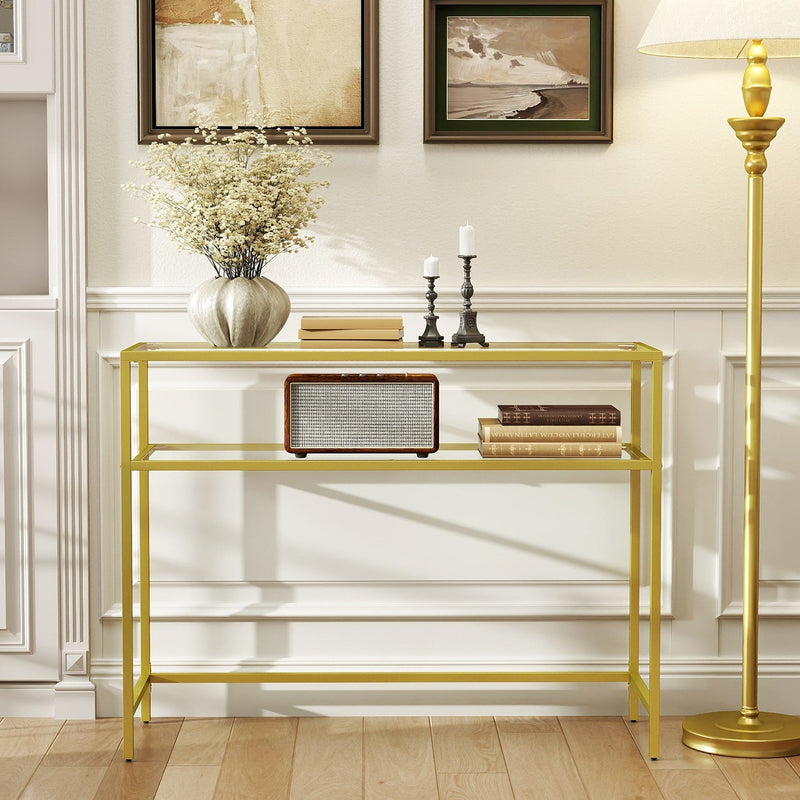 Gold glass console table styled in a living room with decor