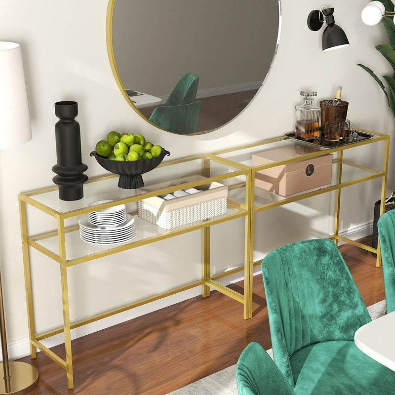 Gold glass console table positioned beneath a round mirror in a hallway