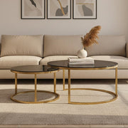 Gold and glass round nesting coffee tables styled in a living room