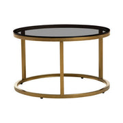 Gold and glass round nesting coffee tables studio shot, angled view