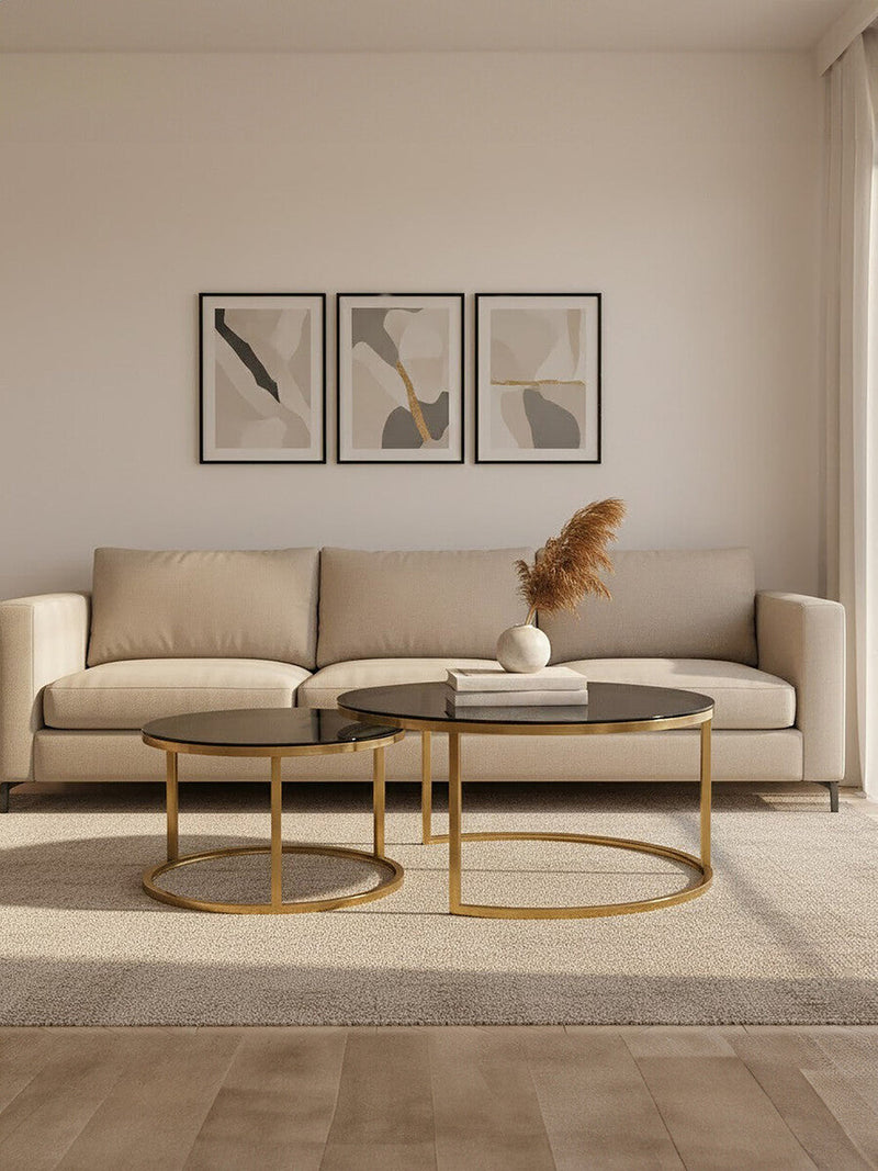 Gold and glass round nesting coffee tables styled in a lounge setting