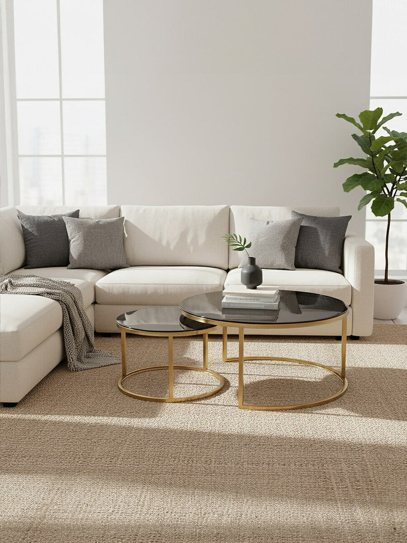 Gold and glass round nesting coffee tables styled in a living room setting