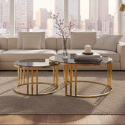 Gold metal and tinted glass round nesting coffee tables styled in a living room
