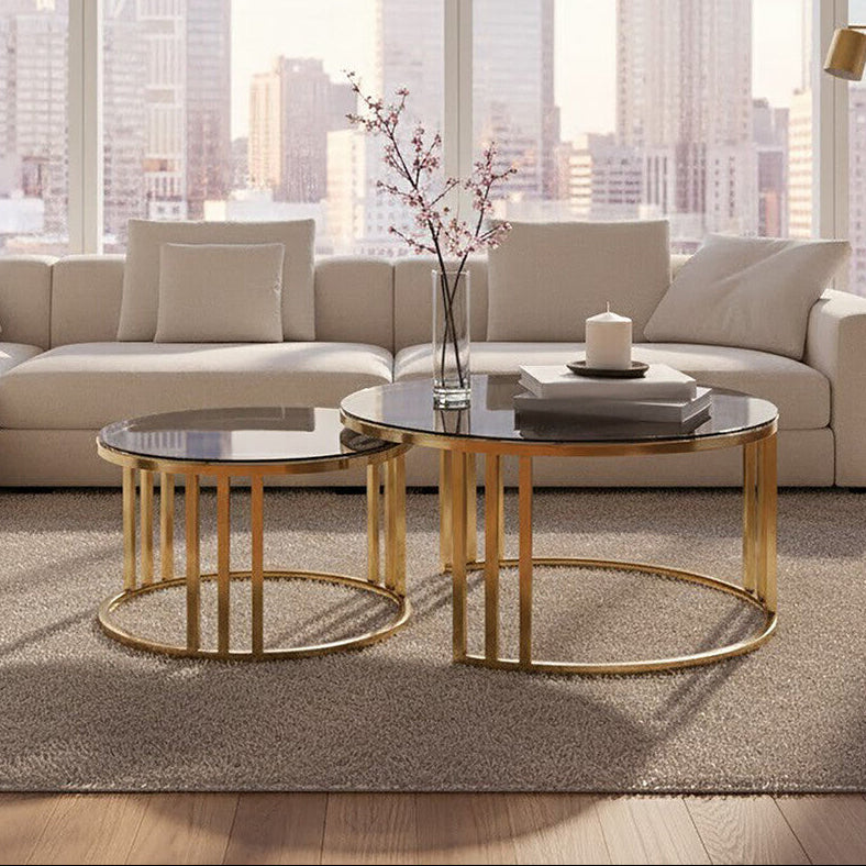Gold metal and tinted glass round nesting coffee tables styled in a living room