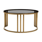 Gold round nesting coffee tables nested together, studio shot