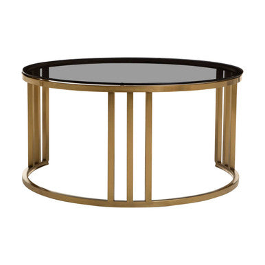 Gold round nesting coffee tables nested together, studio shot