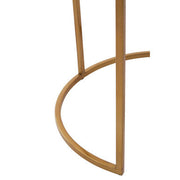 Close-up of the gold finish on the slim metal table frame