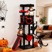 Three cats in Halloween costumes climbing and resting on the Gothic cat tree in a living room