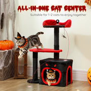 Cat leaping toward the cat tree while another cat rests inside the coffin-style cat house