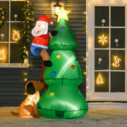 Lit inflatable Christmas tree, Santa and dog in front of a house with window decorations