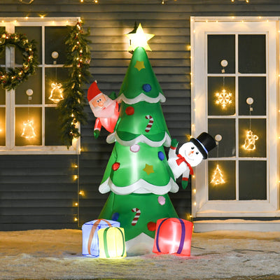 Lit inflatable Christmas tree with Santa and snowman beside a house with fairy lights