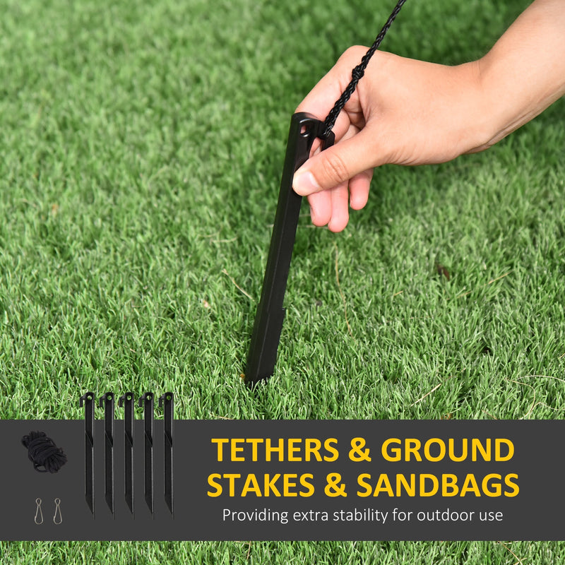 Hand pushing a black ground stake into grass with tethers and stakes callout