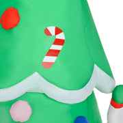 Close-up of tree fabric with a candy cane, red bauble and white snow trim