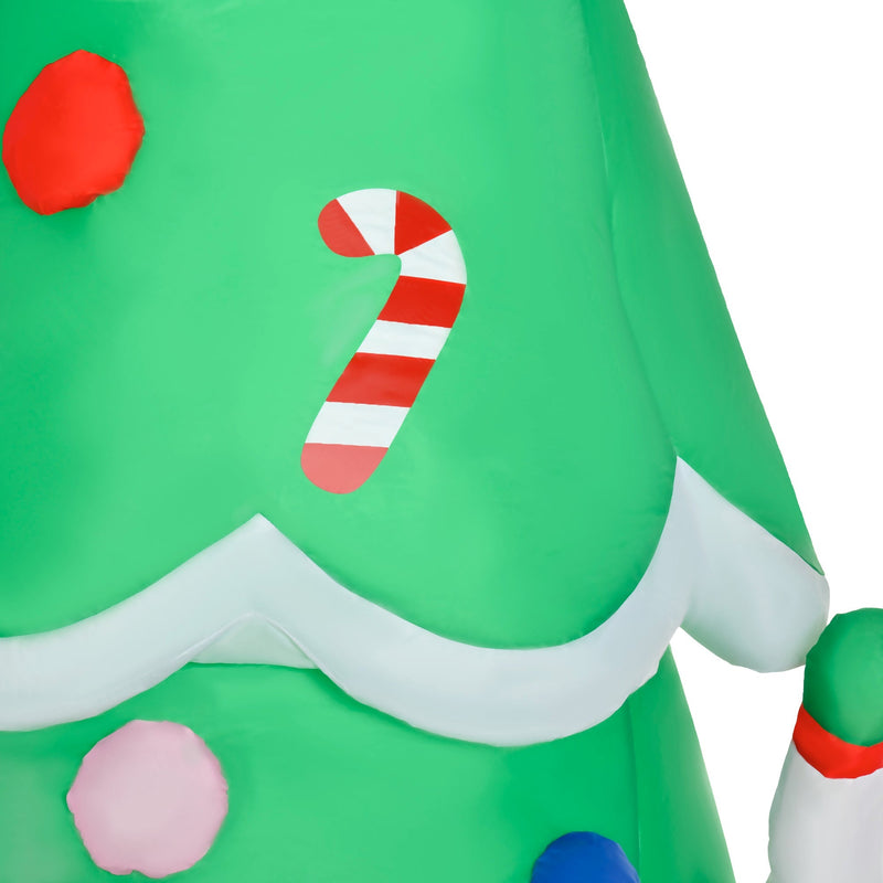 Close-up of tree fabric with a candy cane, red bauble and white snow trim