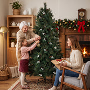 Grandmother and girl decorating the 6ft tree in a living room with a woman unpacking ornaments