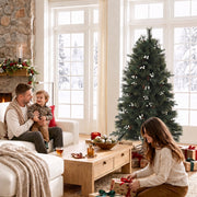 5ft tree in a bright living room with a father and toddler on the sofa and a girl wrapping a gift