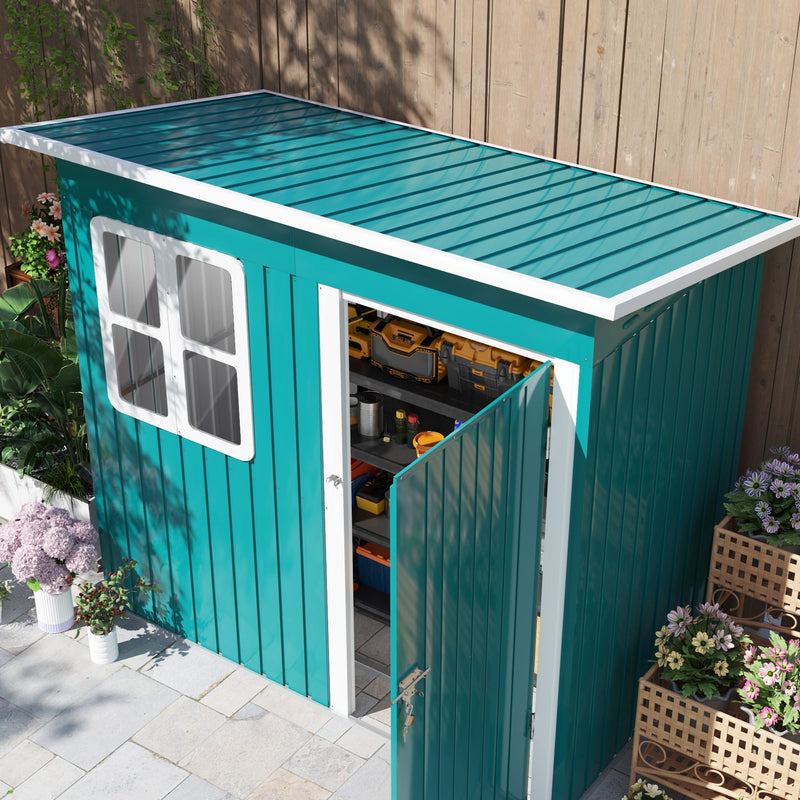 Raised view of the green shed showing the sloping pent roof and the open door with tools stored inside