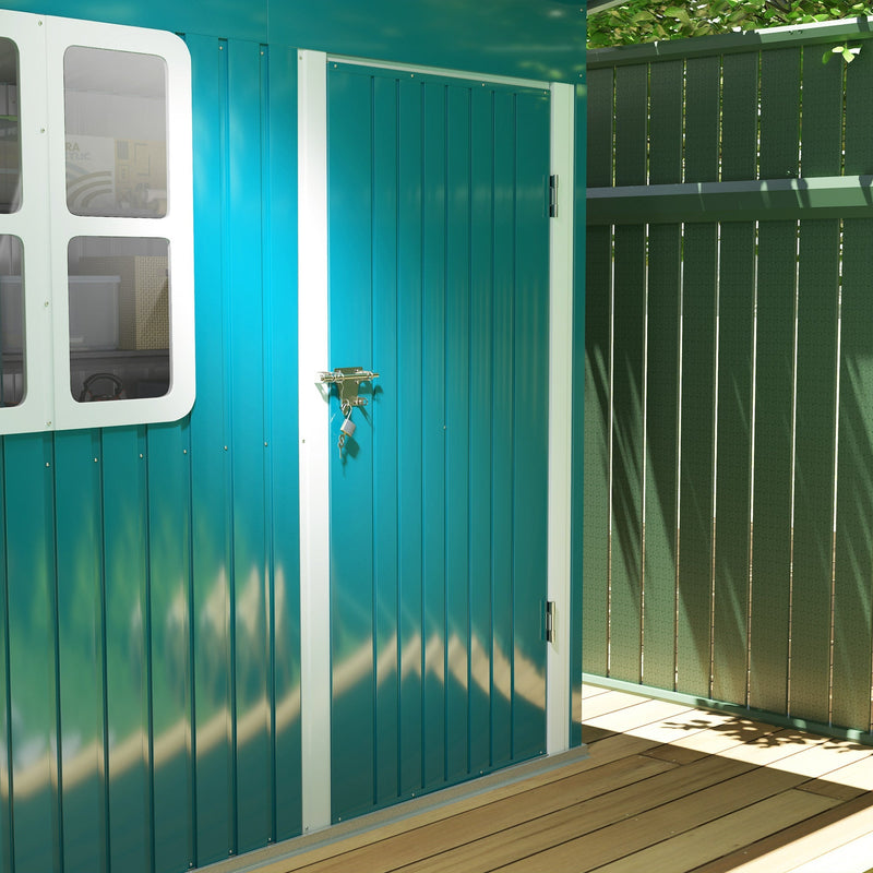 Close-up of the green corrugated steel door, handle and white-framed window on the front of the shed
