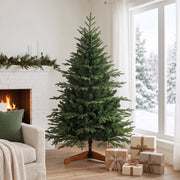 5ft tree in a living room beside a white brick fireplace with gifts underneath