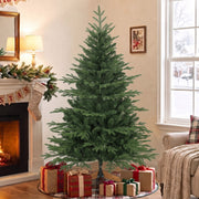 5ft Christmas tree beside a fireplace with wrapped presents at its base