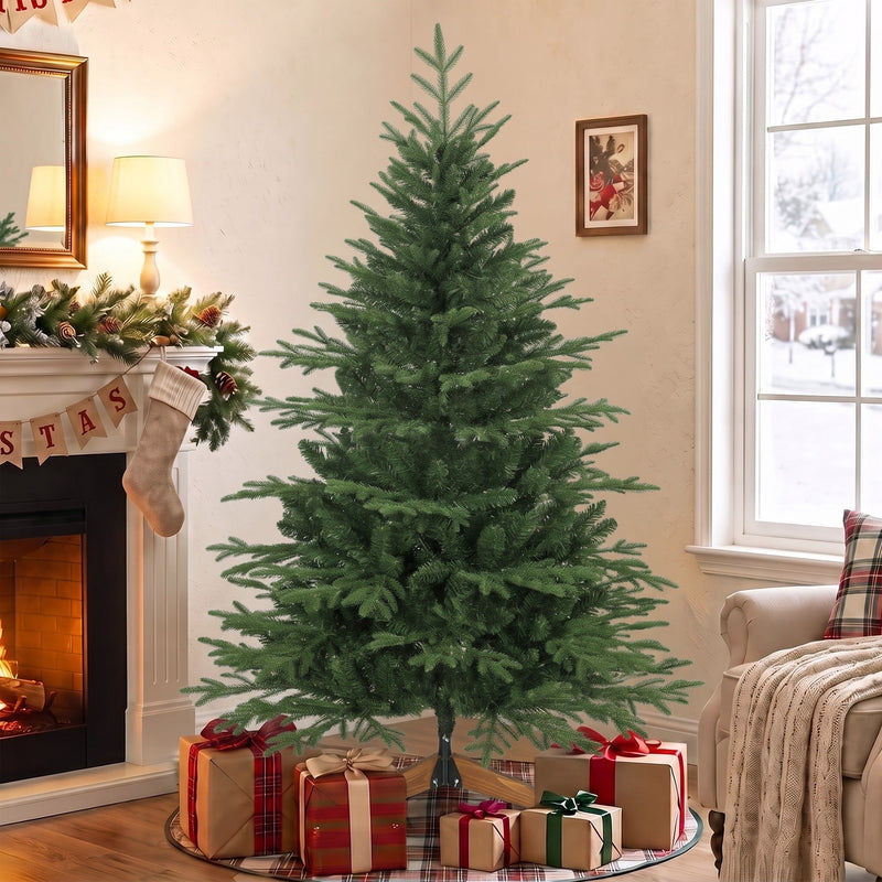 5ft Christmas tree beside a fireplace with wrapped presents at its base