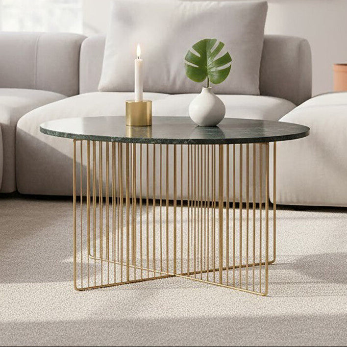 Green marble round coffee table with gold iron frame in a living room setting
