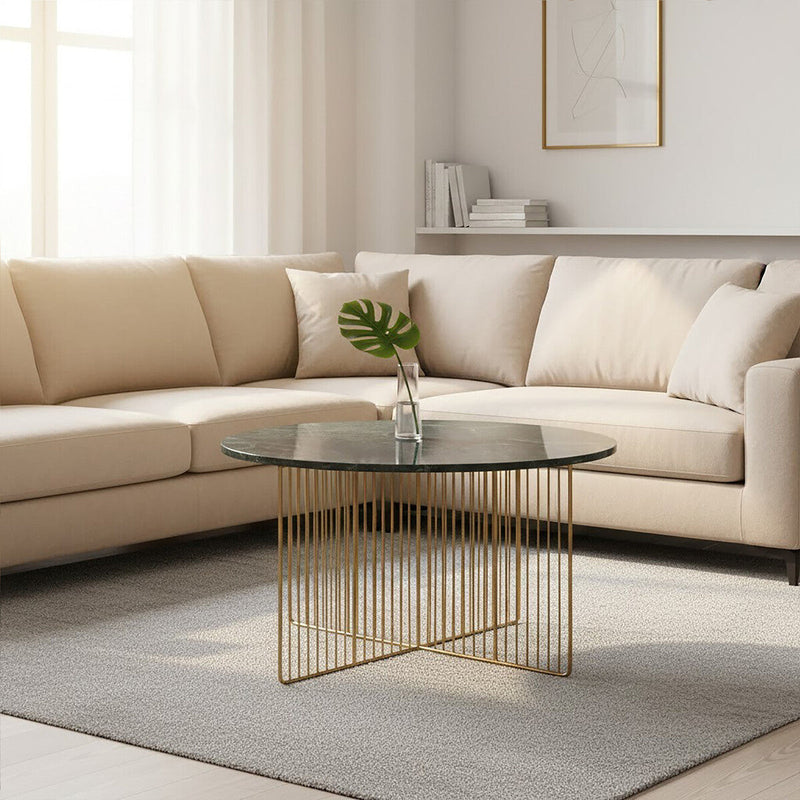 Green marble coffee table styled beside a sofa in a compact lounge