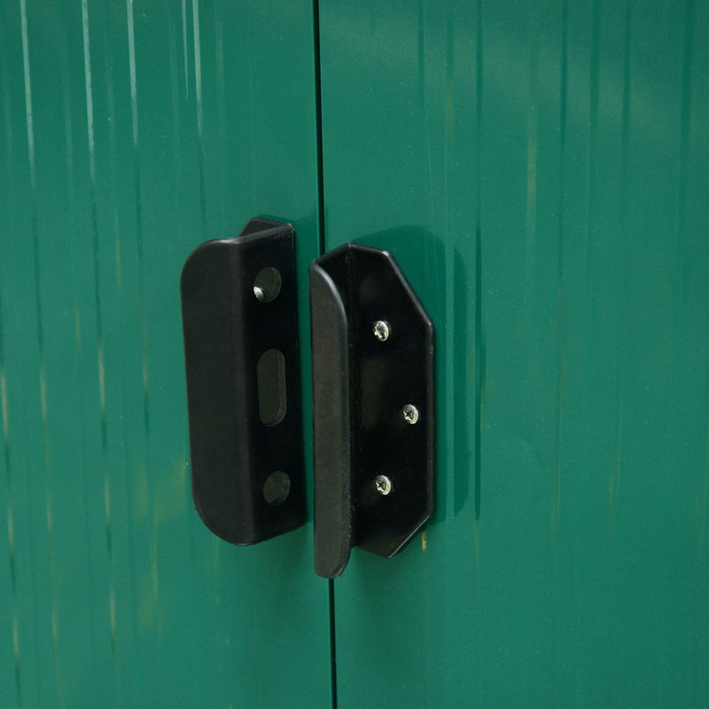 Detail of the two-piece black door handle on the green shed, showing the screw fixings and padlock slot