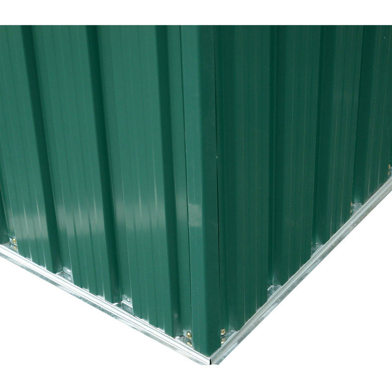 Close-up of the shed's rear corner where the ribbed green cladding meets the galvanised steel base frame