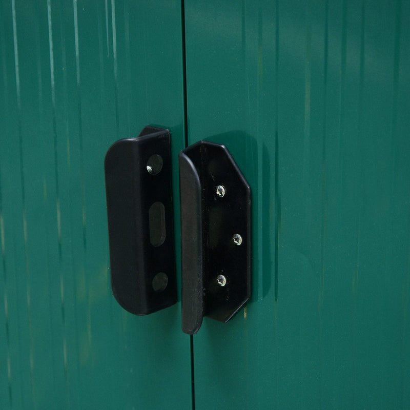 Green shed door handle photographed from the front, with the padlock slot centred between both doors