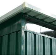 Corner detail showing the pent roof overhang above a clear polycarbonate panel and green ribbed cladding
