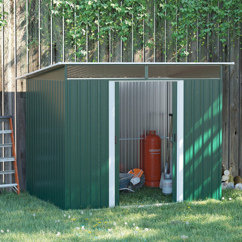 Green metal shed against a garden fence with the doors open and a gas bottle and tools stored inside