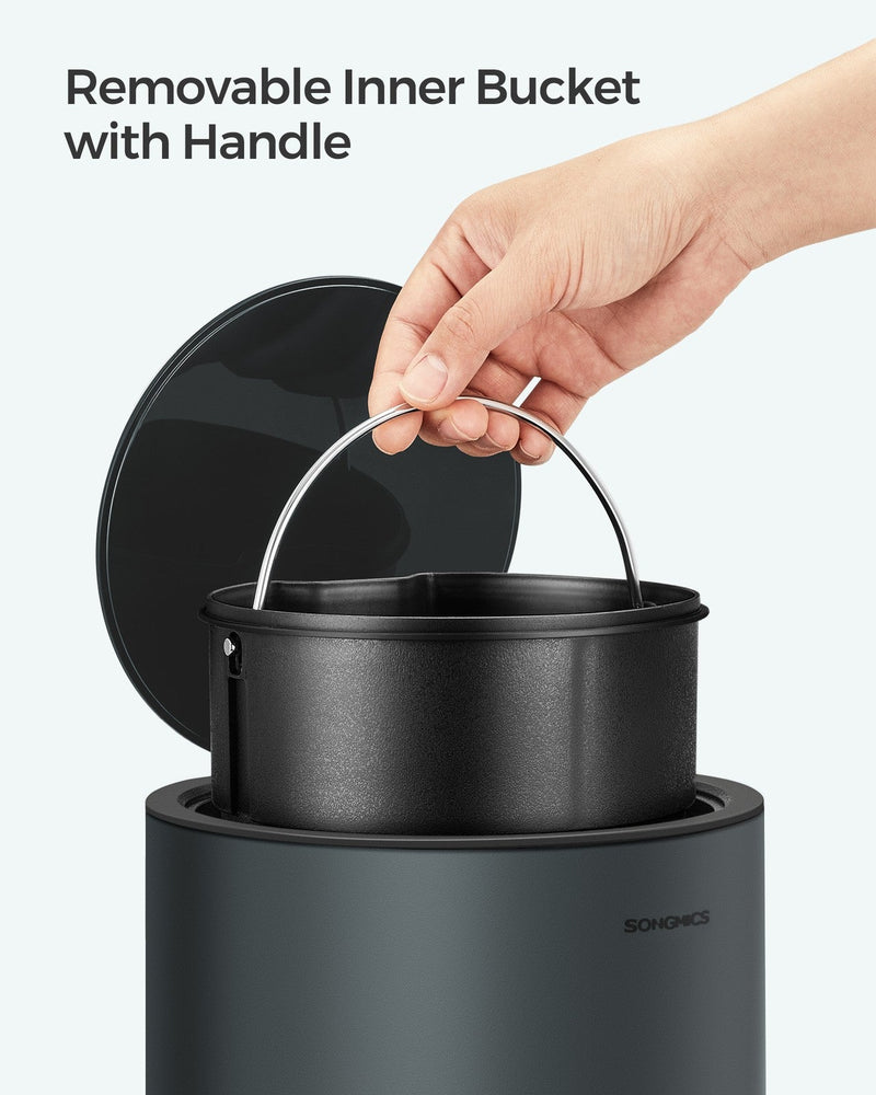 Hand lifting the inner bucket out of the bin by its wire handle