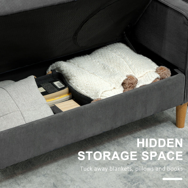 Storage compartment open under the seat, showing a blanket and books tucked inside