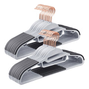 Two stacks of grey plastic coat hangers with rose gold swivel hooks and black non-slip pads