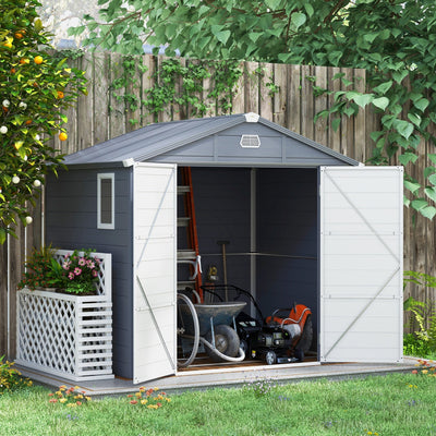 Grey plastic shed in a garden with doors open, holding a wheelbarrow, mower and ladder
